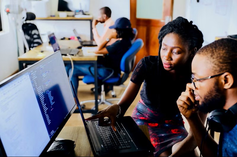African entrepreneur smiling while working on modern business growth plans